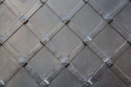 Image of metal painted surface with ornament of rhombus