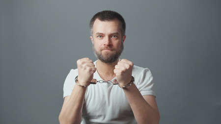 Photo of the arrested man with handcuffs
