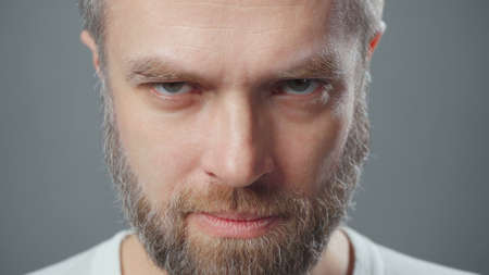 Extreme close-up photo of man looking under his brows