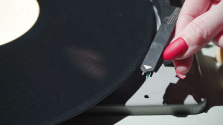 Shot of woman with red nails and retro gramophoneの写真素材