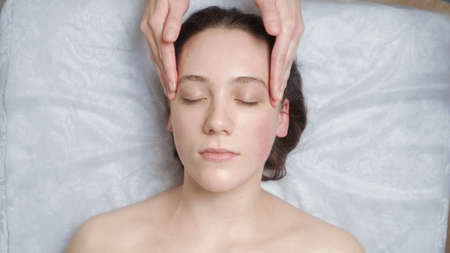 Photo of woman gets a facial massageの写真素材
