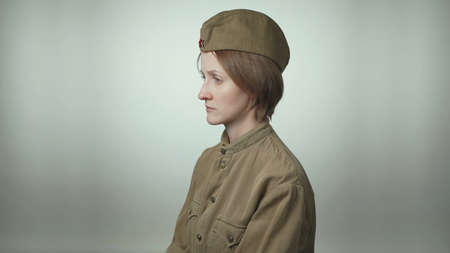 Photo of woman wearing red army uniform on white