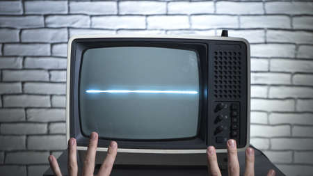 Photo of retro tv and humans handsの写真素材