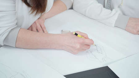 Two young businesswomen discussing work in officeの写真素材