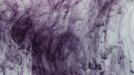 Pattern of drops of purple paint falling in waterの写真素材