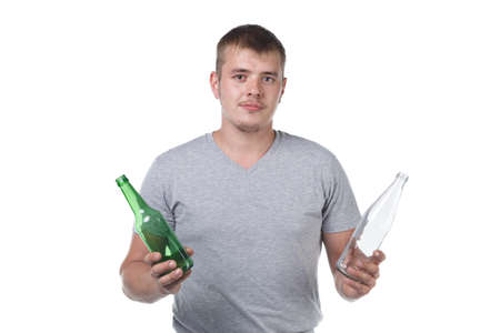 Photo of young man with bristle holding empty glass bottlesの写真素材