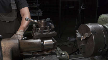 Photo of working process with metal details on lathe machine