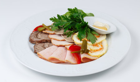 Photo of meat snacks on plate on white background, top viewの写真素材