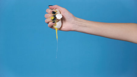 Photo of the smashed egg in womans hand