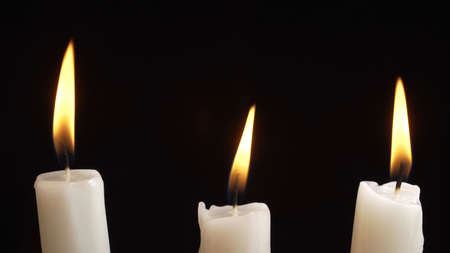 Shooting of burning a three candles on dark backgroundの写真素材