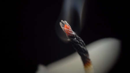 Photo of smouldering wick on black backgroundの写真素材