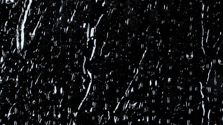 Shot of the water drops on black glassの写真素材
