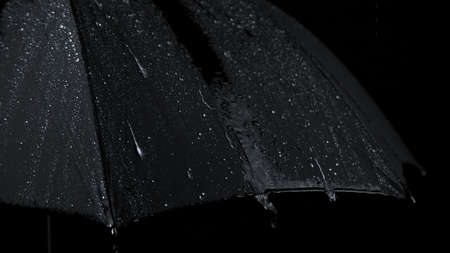 Close-up shooting of black umbrella and rainy dropsの写真素材