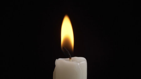 Shooting of burning candle on dark backgroundの写真素材
