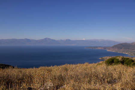 at greece in a bay an a hill with flowersの写真素材