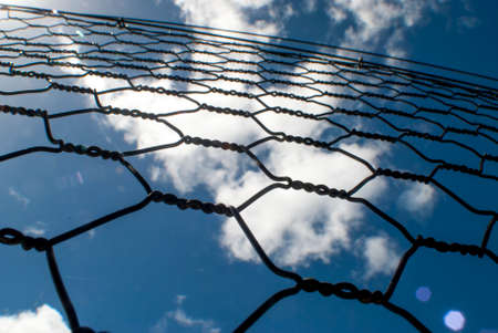 chain link fence with a blue sky background