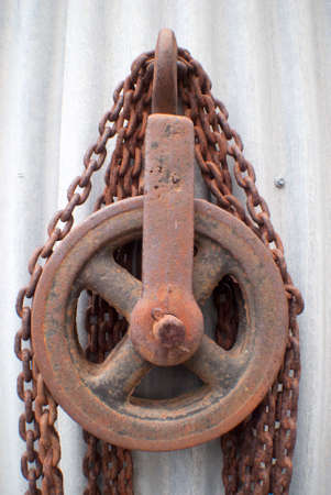 rusted chain on a pulleyの写真素材