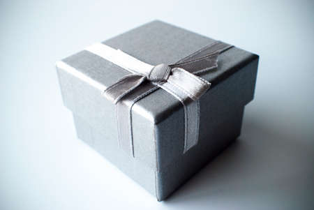 grey gift box with silver grey ribbonの写真素材