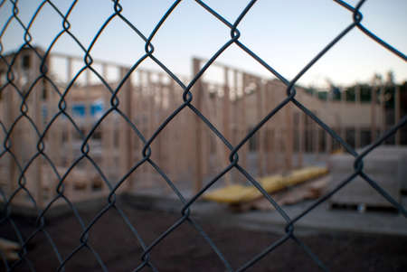 building site through wire fenceの写真素材