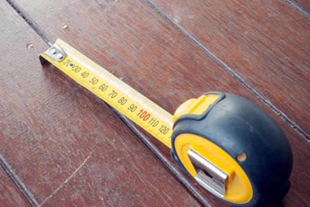 measuring tape on timber boardwalk backgroundの写真素材