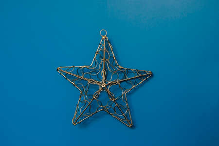 metal christmas star on blue backgroundの写真素材