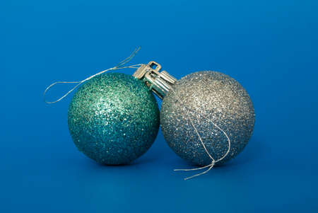 two christmas baubles on blue backgroundの写真素材