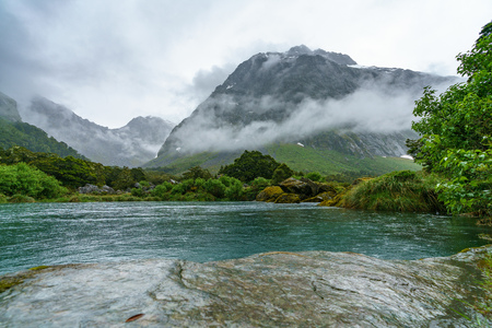 turquoise water of a river in the mountains in the rain, gertrude valley lookout, southland, new zealand turquoise water of a river in the mountains in the rain, gertrude valley lookout, southland, new zealand