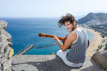 young man is playing guitar at a Viewpointの写真素材