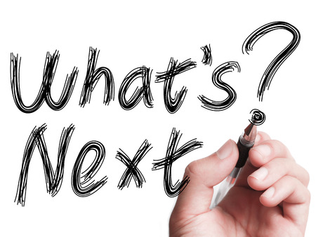 Hand with pen is writing Whats Next on transparent white board.の写真素材