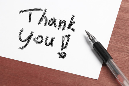 Thank you Concept written on white paper with black pen aside.の写真素材