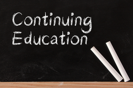 Continuing Education text is written by chalk on blackboard.の写真素材