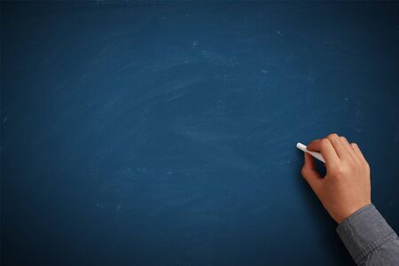 Hand writing on blank blue chalkboard or background.の写真素材