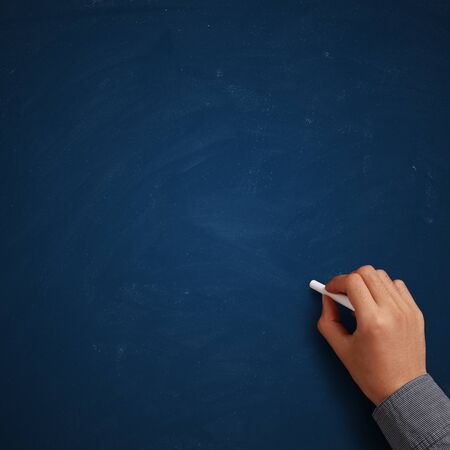 Hand writing on blank blue chalkboard or background.の写真素材