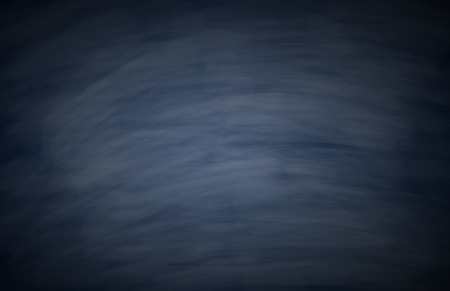 Blank blue chalkboard with chalk traces for background image.の写真素材