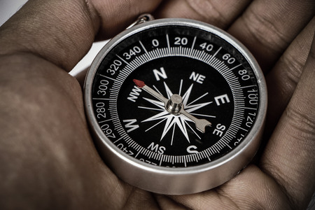 Close-up of a compass is in hand.の写真素材