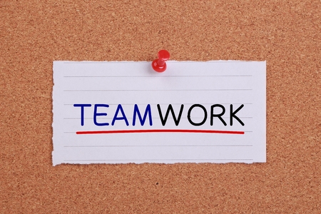 Teamwork text with line written on note paper pinned on corkboard.の写真素材