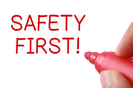 Writing Safety First concept isolated on white background.