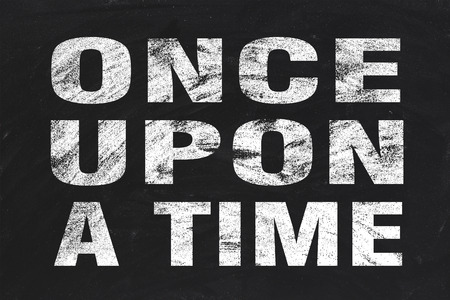 Once upon a time text is written by white chalk on blackboard.の写真素材