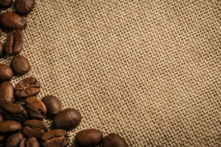 Coffee beans border over burlap sack background. Lots of copy space for edit.の写真素材