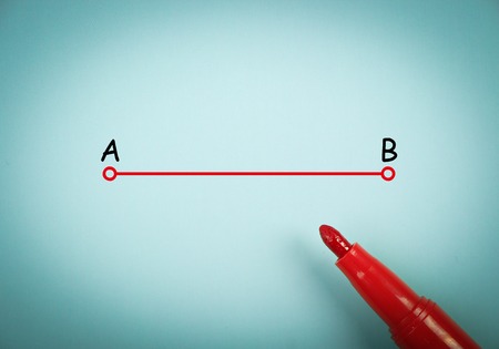 Point a to point b concept is on blue paper with a red marker aside.の写真素材