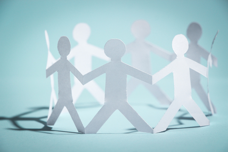 Group of people made of paper are holding hands together. Team concept.の写真素材