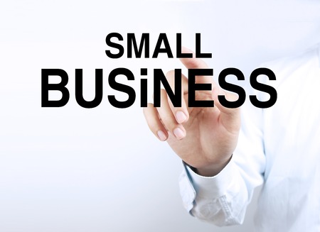 Businessman hand is pressing the concept text of Small Business.の写真素材