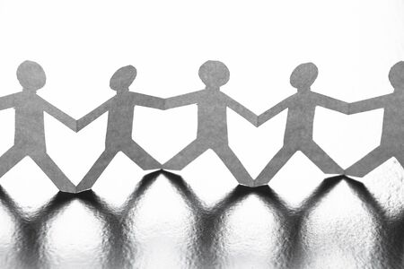 Group of people made of paper are holding hands together. Team concept.の写真素材
