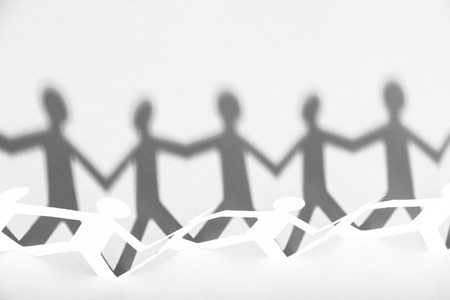 Group of people made of paper are holding hands together. Team concept.の写真素材