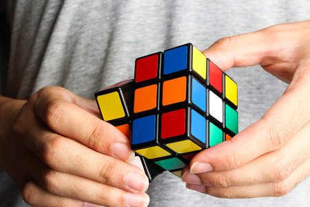 Closeup image of a man playing a rubik's cube.のeditorial素材