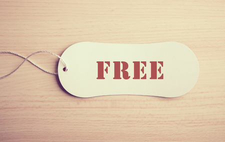 Free label is on the wooden textured background.の写真素材