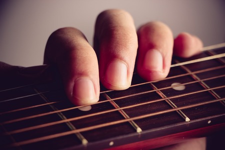 Closeup shot photo of playing the acoustic guitar.の写真素材