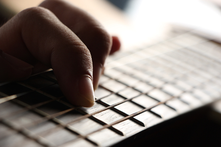 Closeup shot photo of playing the acoustic guitar.の写真素材