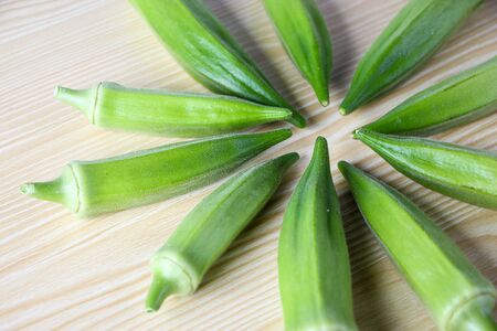 Fresh okra on the wooden table background.の写真素材