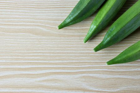 Fresh okra on the wooden table background.の写真素材